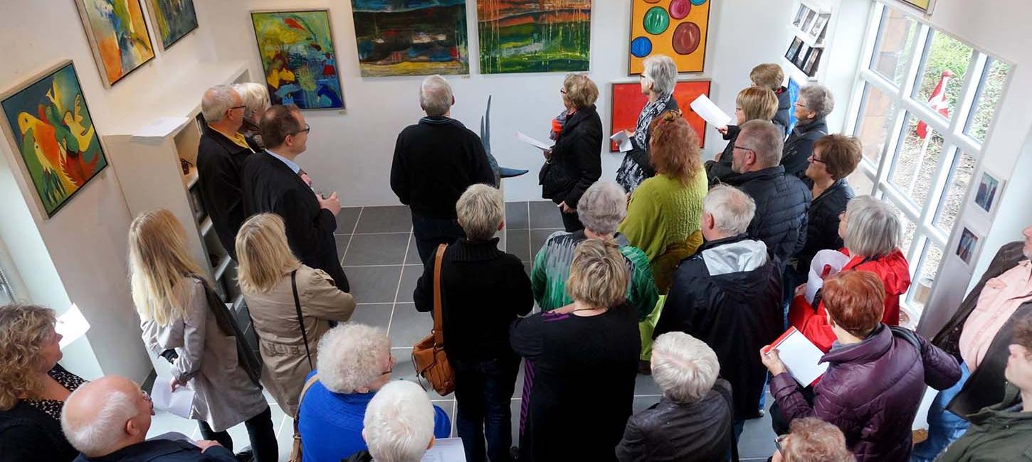 Guests are gathered for the exhibition at the Workshop Gallery