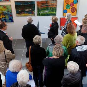 Guests are gathered for the exhibition at the Workshop Gallery
